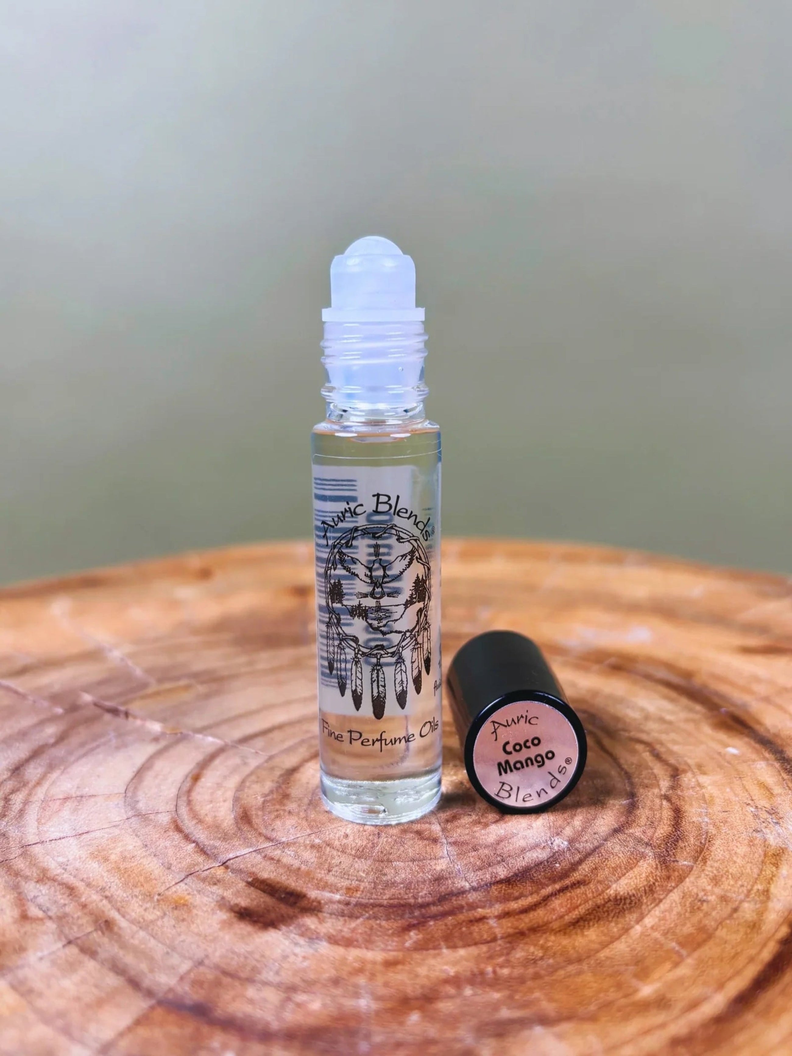 Roll-on perfume bottle with cap on a wooden surface