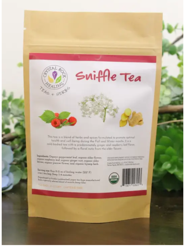 Sniffle Tea package with herbs on a natural background